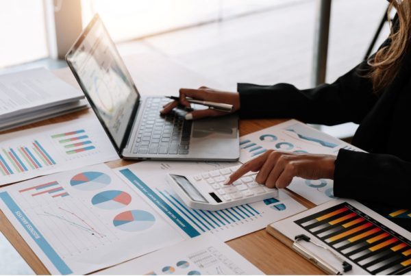 Benefits of outsourcing bookkeeping - Bookkeeper working on documents