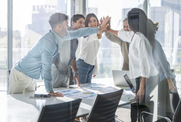 Business team celebrating success with a high five.